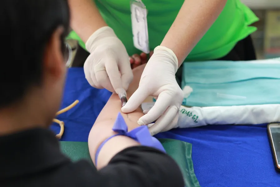 A healthcare worker wearing gloves preparing to provide skilled nursing care